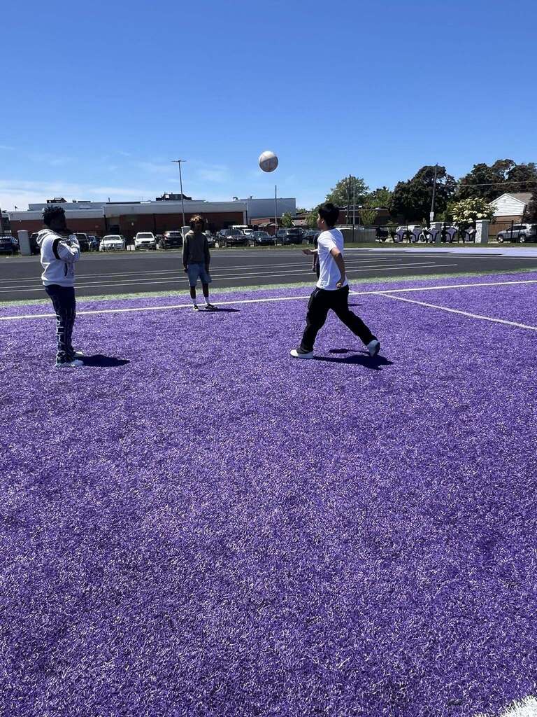 Students playing soccer on Erie High field during field day.