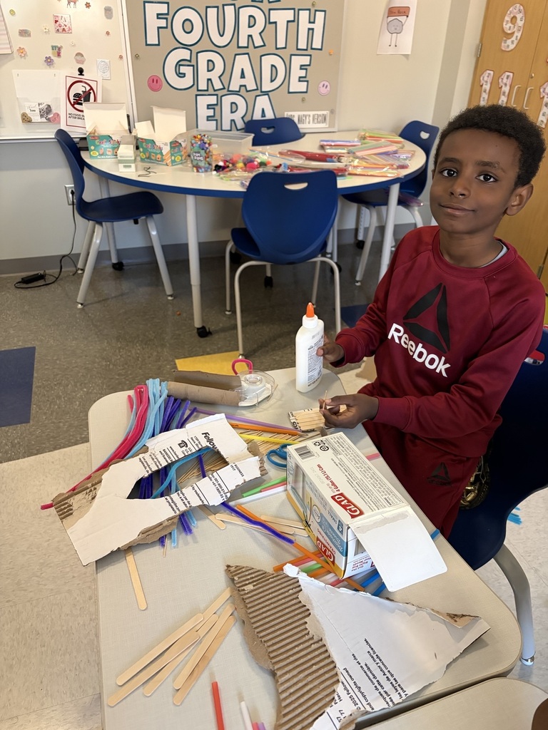 Student using materials to construct their own boats.