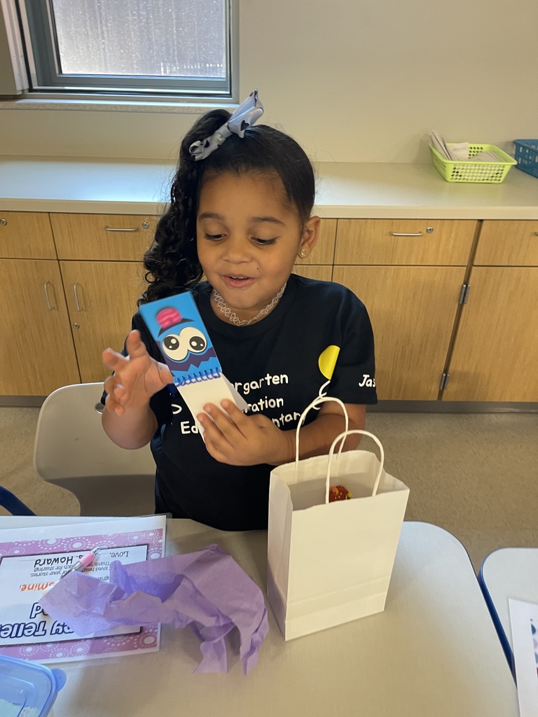 Student smiling with their end of the year gift.