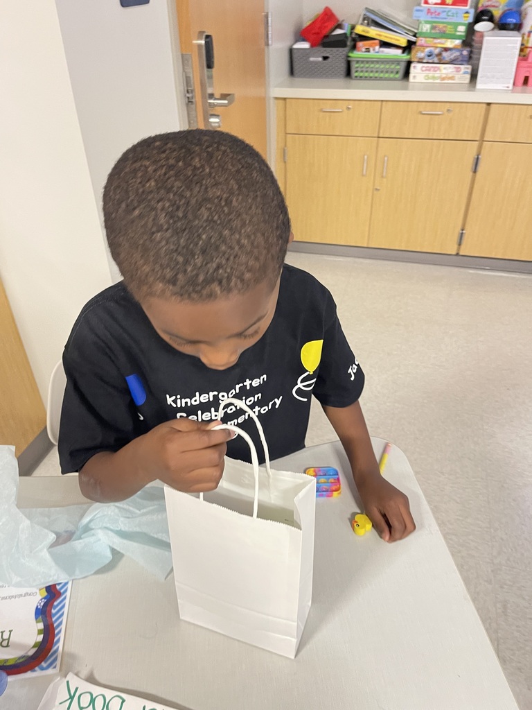 Student smiling with their end of the year gift.