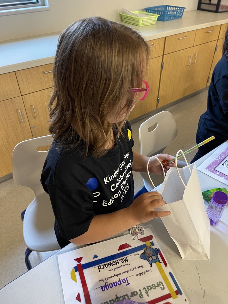 Student smiling with their end of the year gift.
