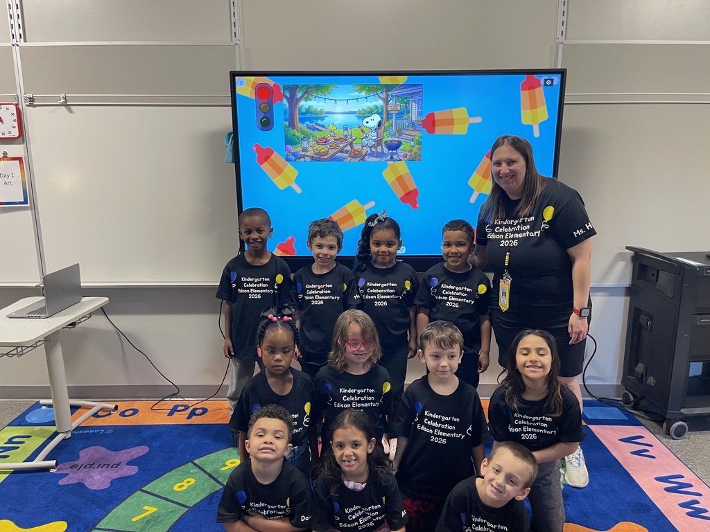 Class picture in front of a smart board.