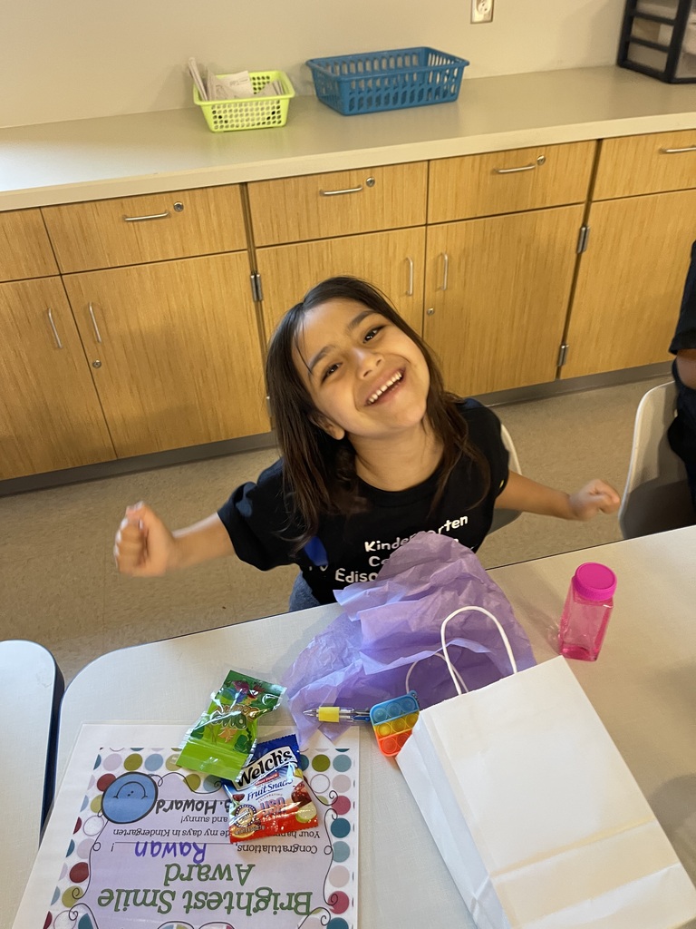 Student smiling with their end of the year gift.