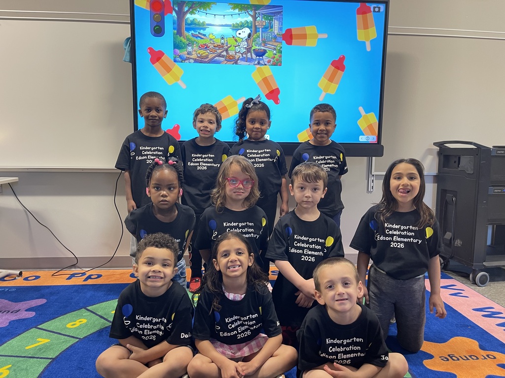Class picture in front of a smart board.