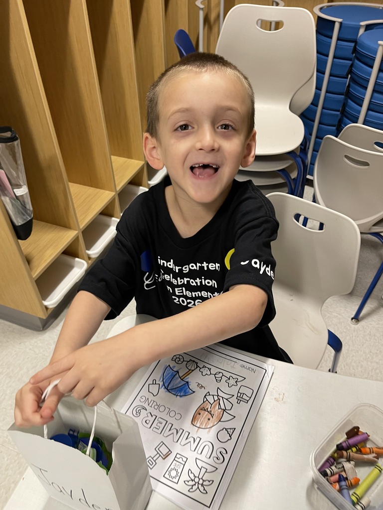 Student smiling with their end of the year gift.