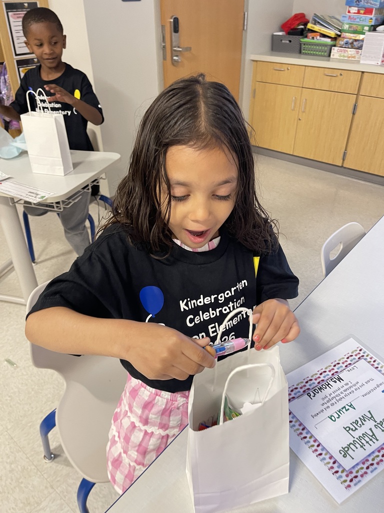 Student smiling with their end of the year gift.