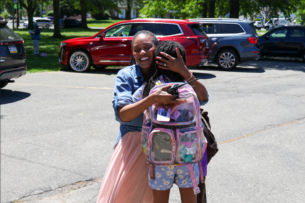 Principal, Deanna McFarland hugging student.