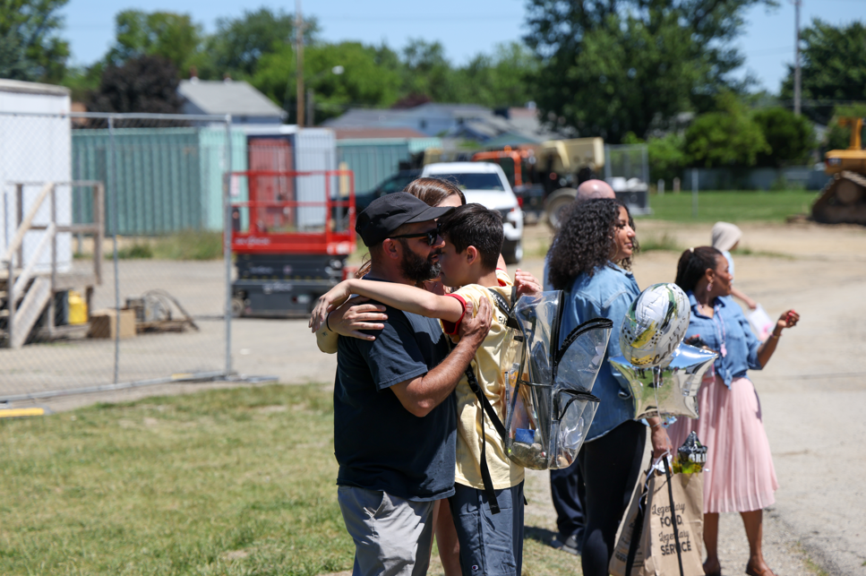 Student hugging his dad on the last day of school. 
