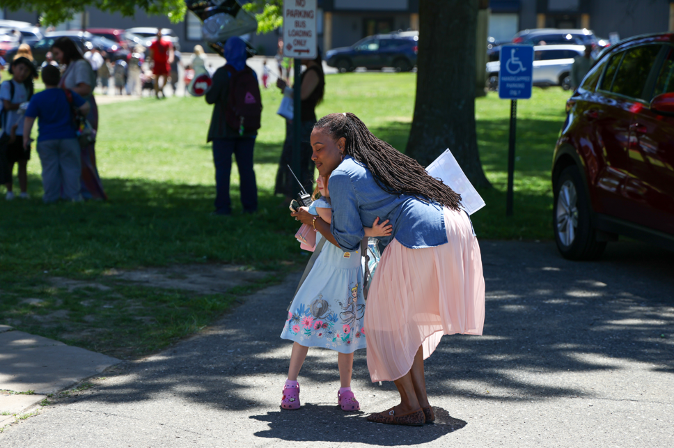 Principal, Deanna McFarland hugging student.