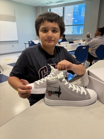 Student with their finished sneakers.