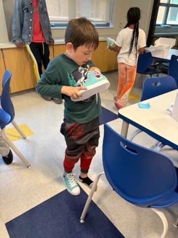 Student with their finished sneakers.