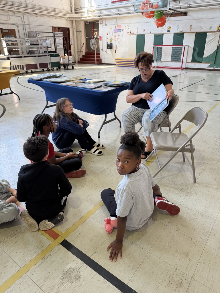 Students being read to by a volunteer