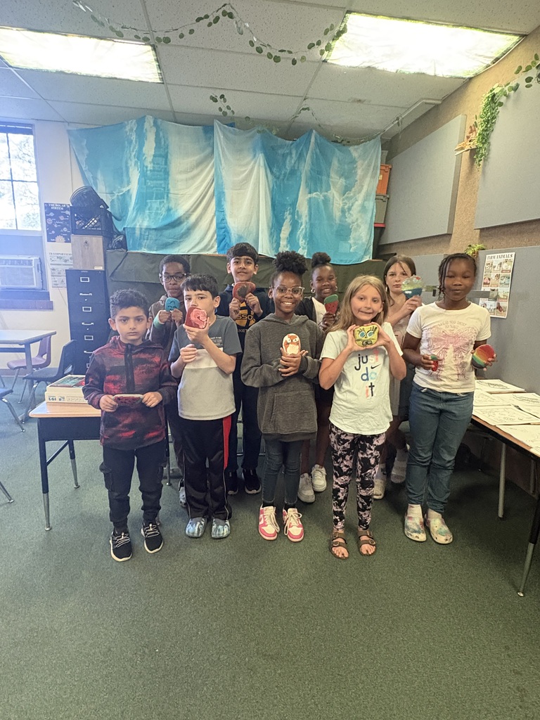 Students holding the rocks they painted.