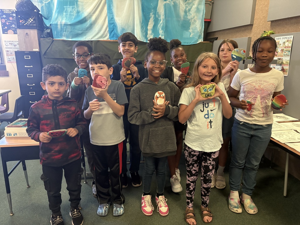Students holding the rocks they painted.