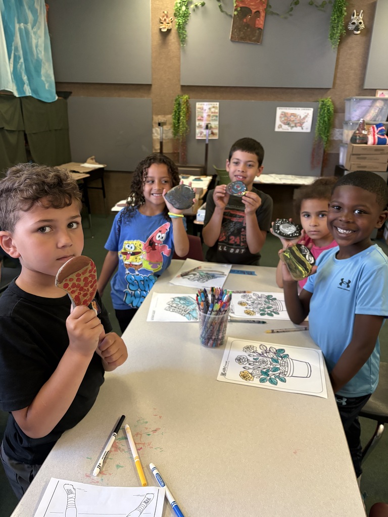 Students holding the rocks they painted.