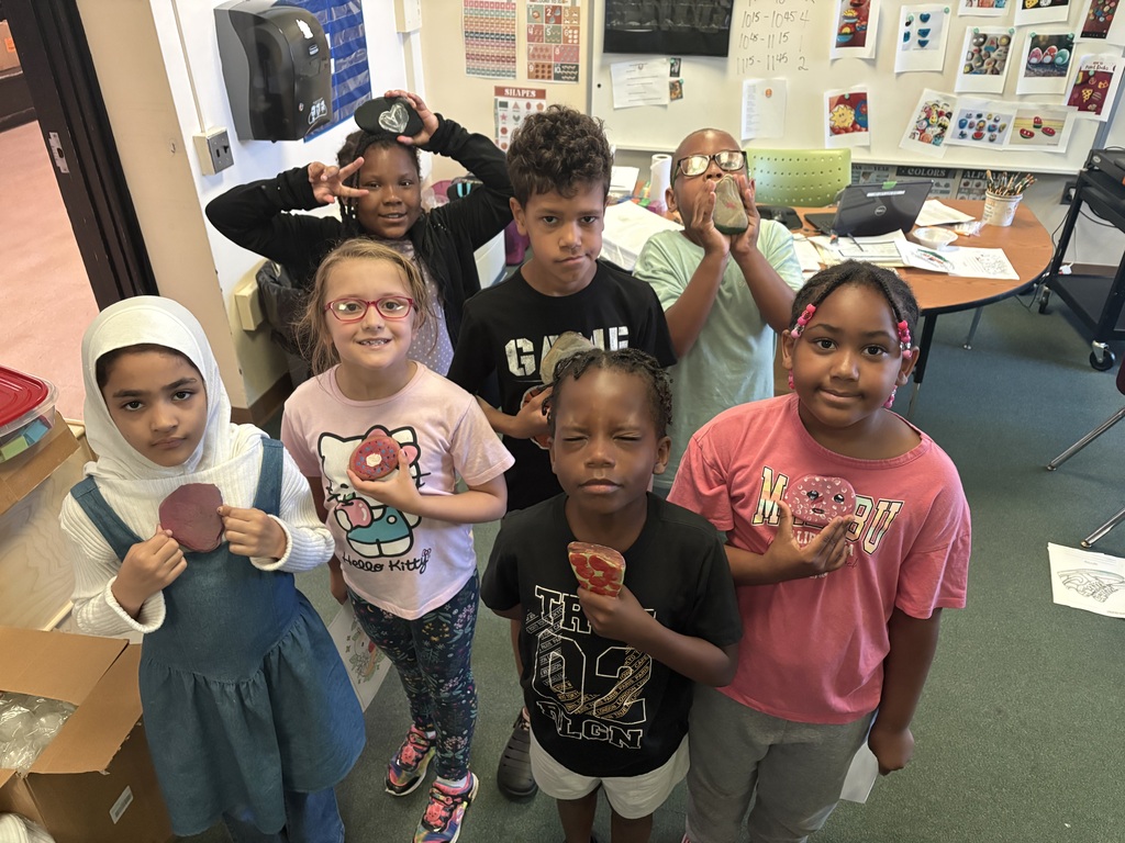 Students holding the rocks they painted.