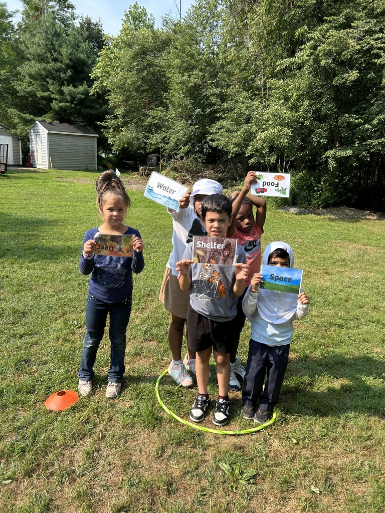 Students standing inside a hoola hoop posing for a picture.