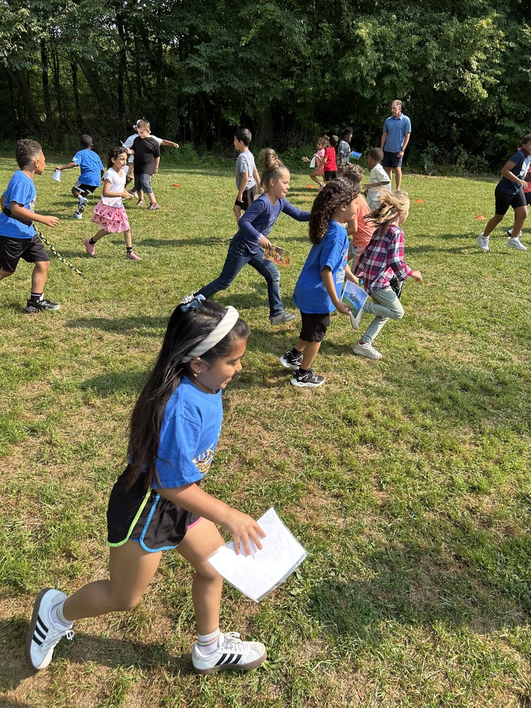 Students running in a field.