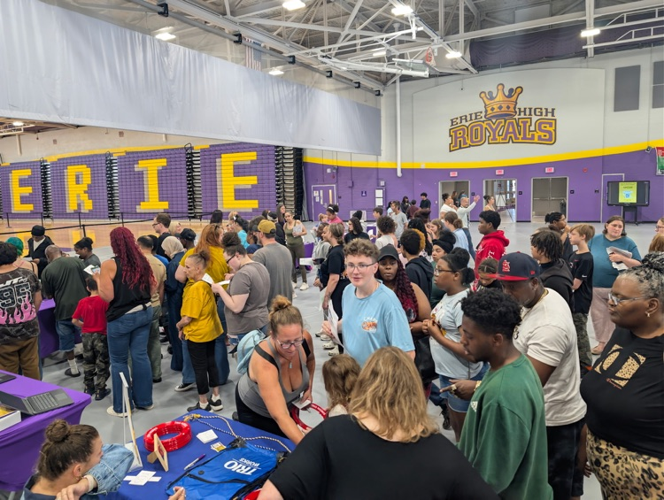 Students and families interacting with resource tables at Erie High Freshmen Orientation Night.