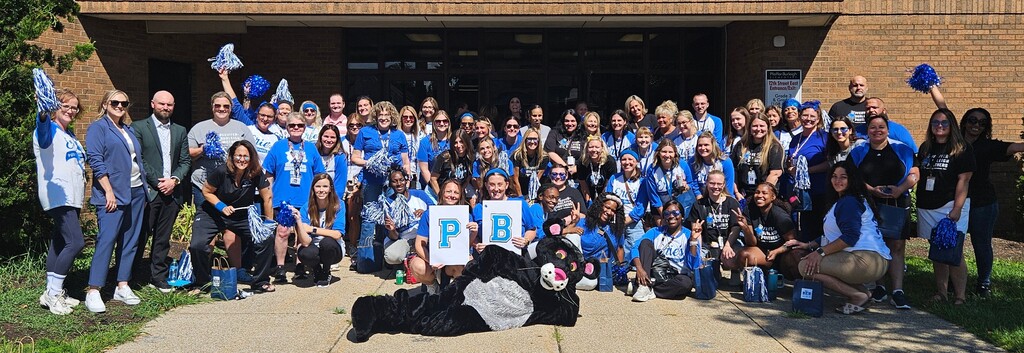 Pfeiffer Burleigh staff and teachers in front of school with panther mascot