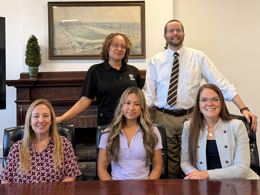 Serena Xu, who was named a National Merit Scholarship Program Semifinalist, poses with the Collegiate Academy deans and counselors