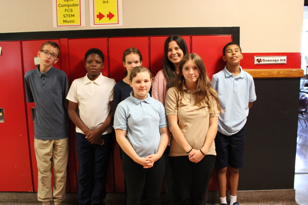 students with an adult staff member by lockers