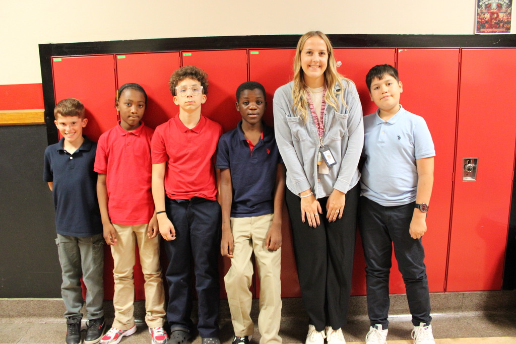 students with an adult staff member by lockers