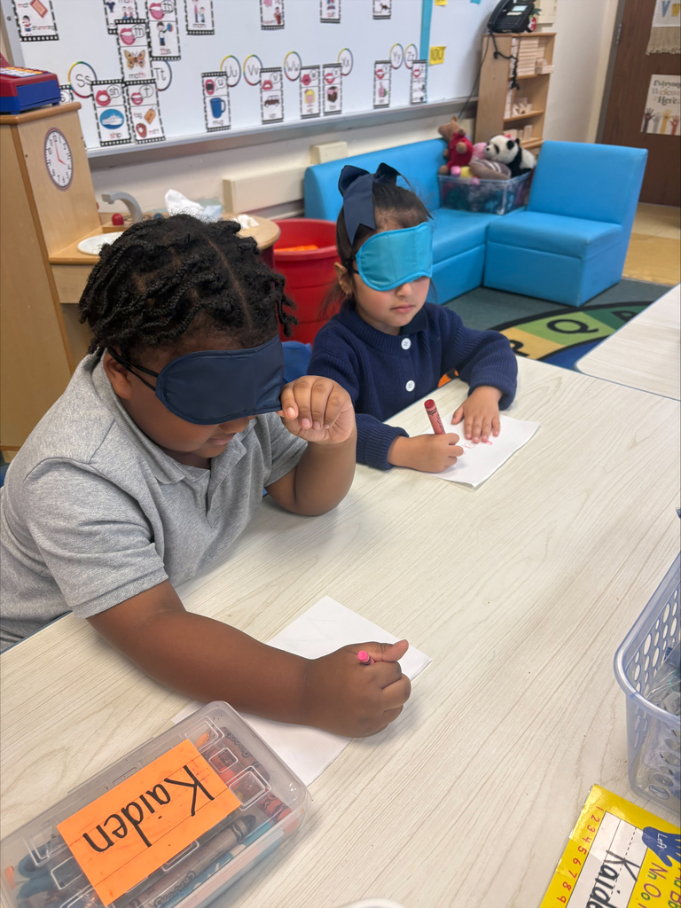 Students writing with an eye mask on