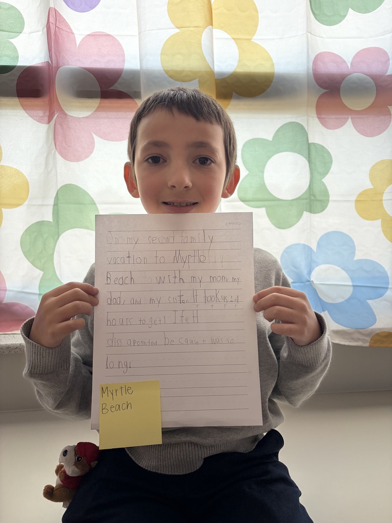 Student holding their paper