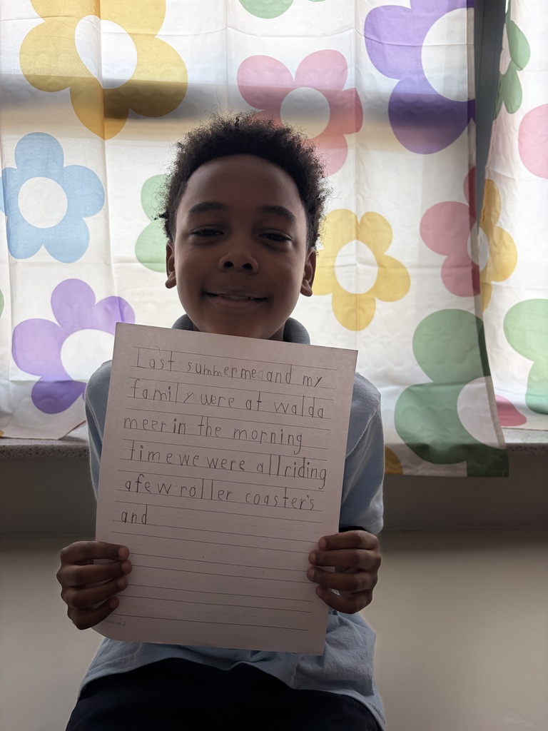 Student holding their paper