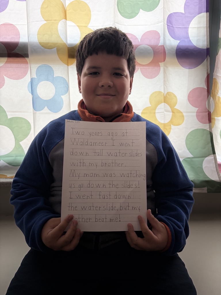 Student holding their paper