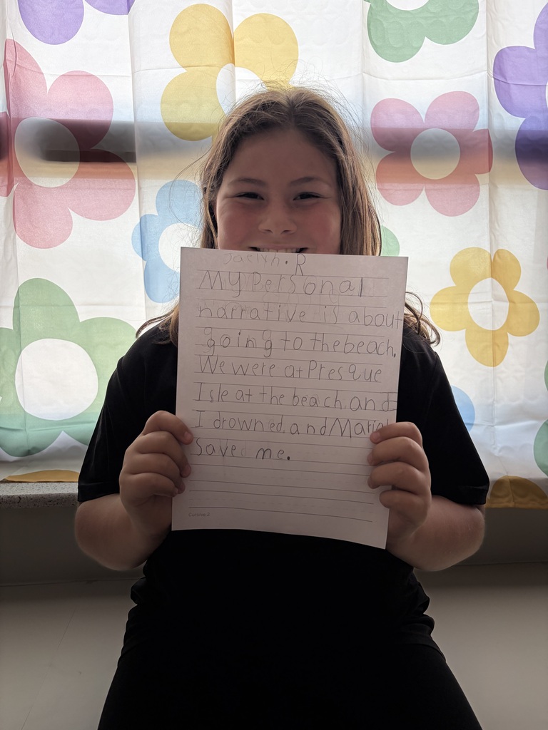 Student holding their paper