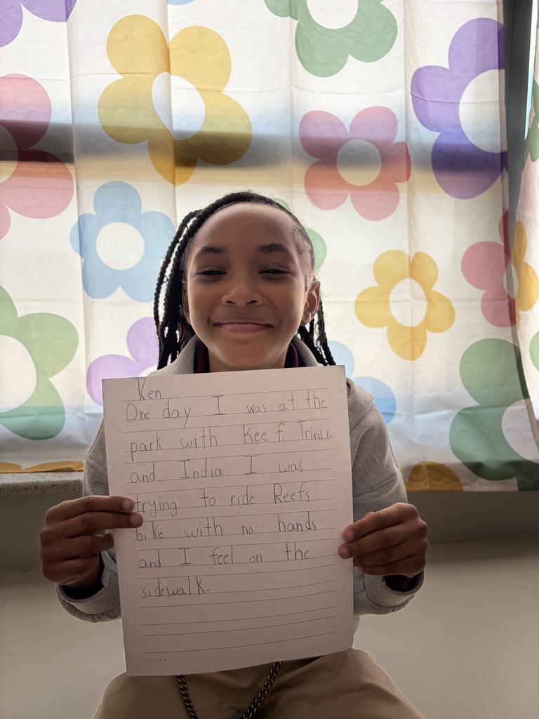 Student holding their paper