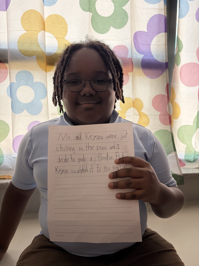 Student holding their paper