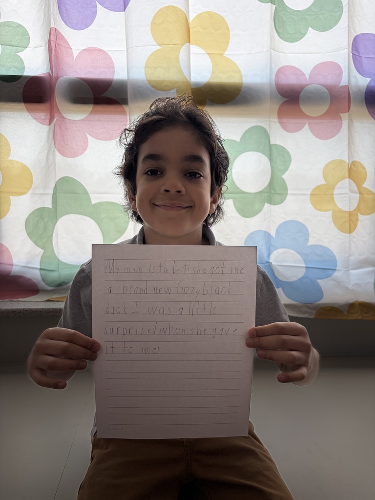 Student holding their paper