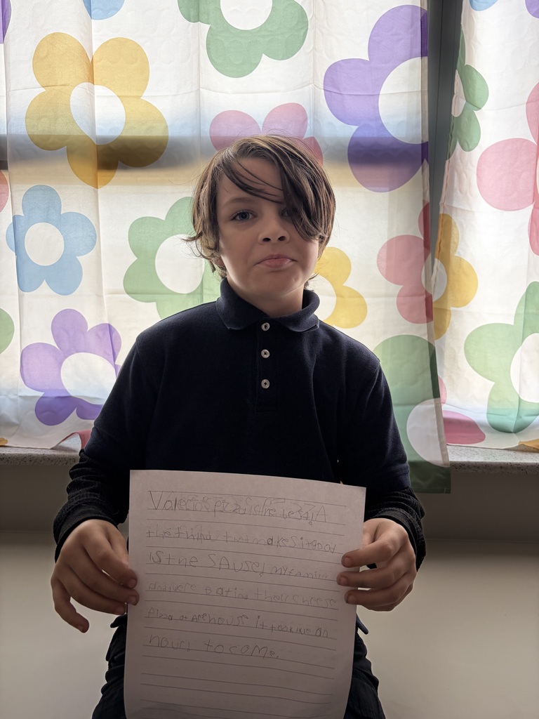 Student holding their paper
