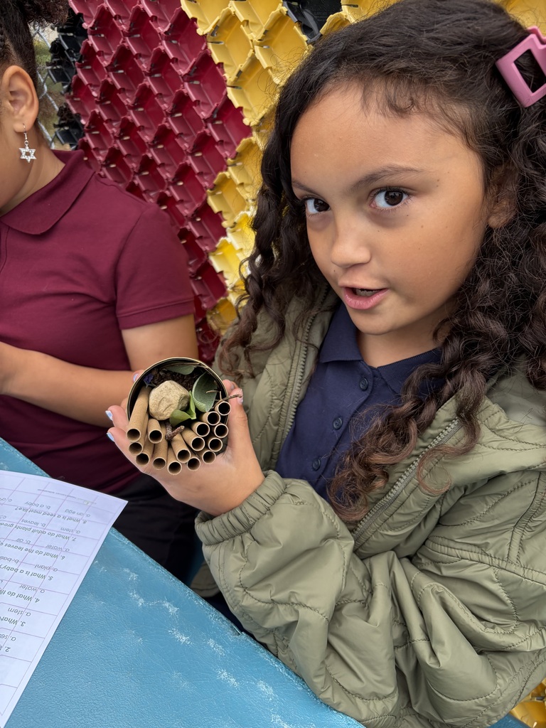 Student holding a solitary bee home.