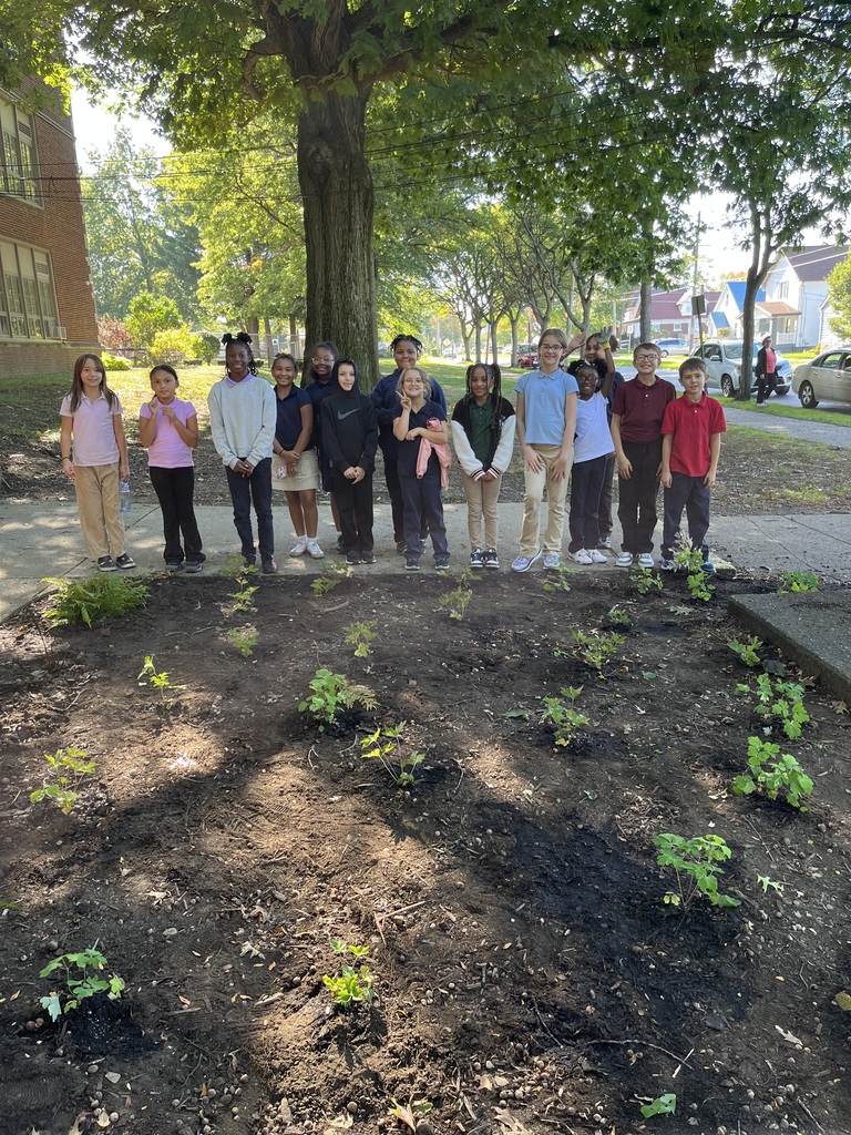 Garden club students standing in front of the new garden they planted