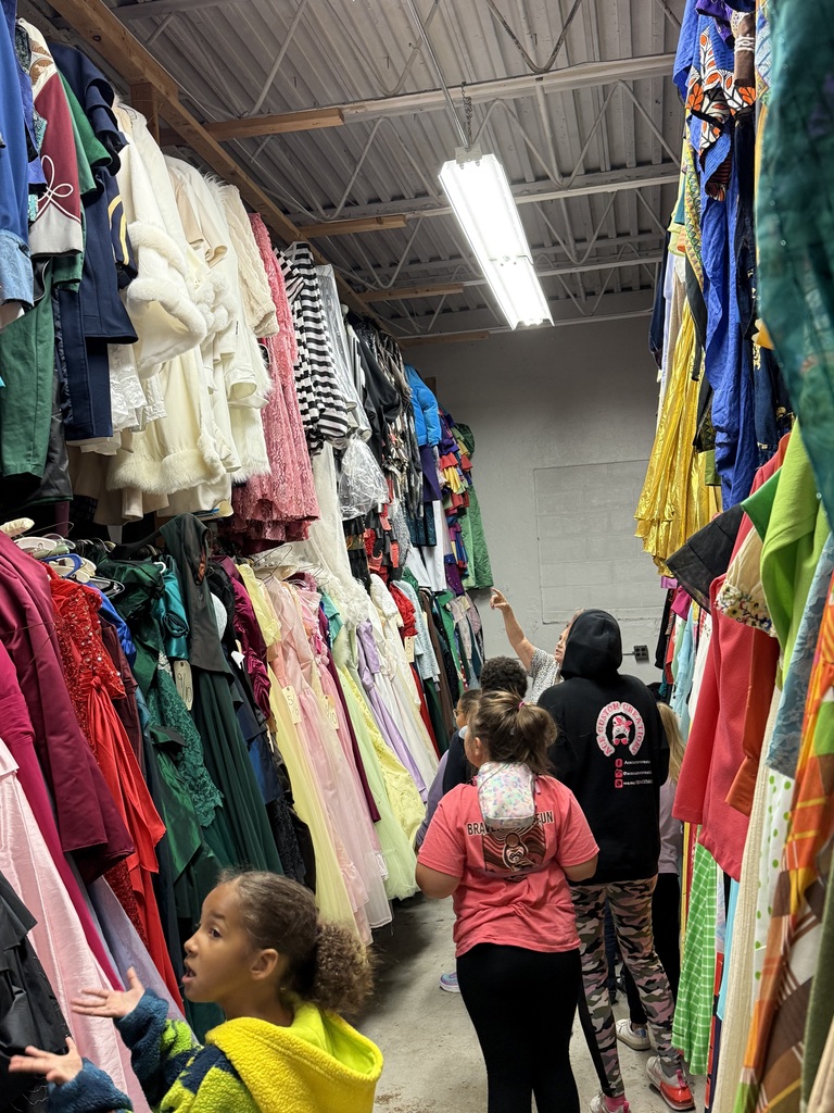 Families exploring the costume storage area at the Playhouse 