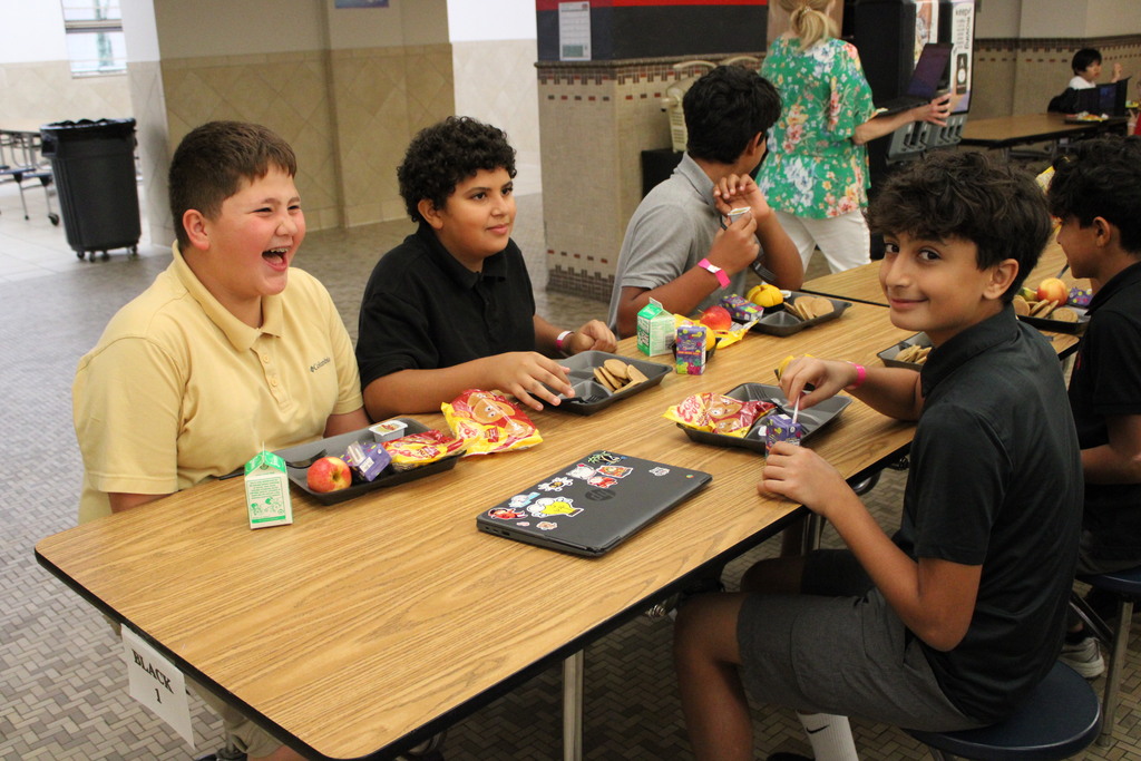 students laughing at a table