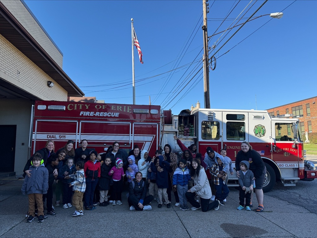 Students posing for a picture in front of the firetruck