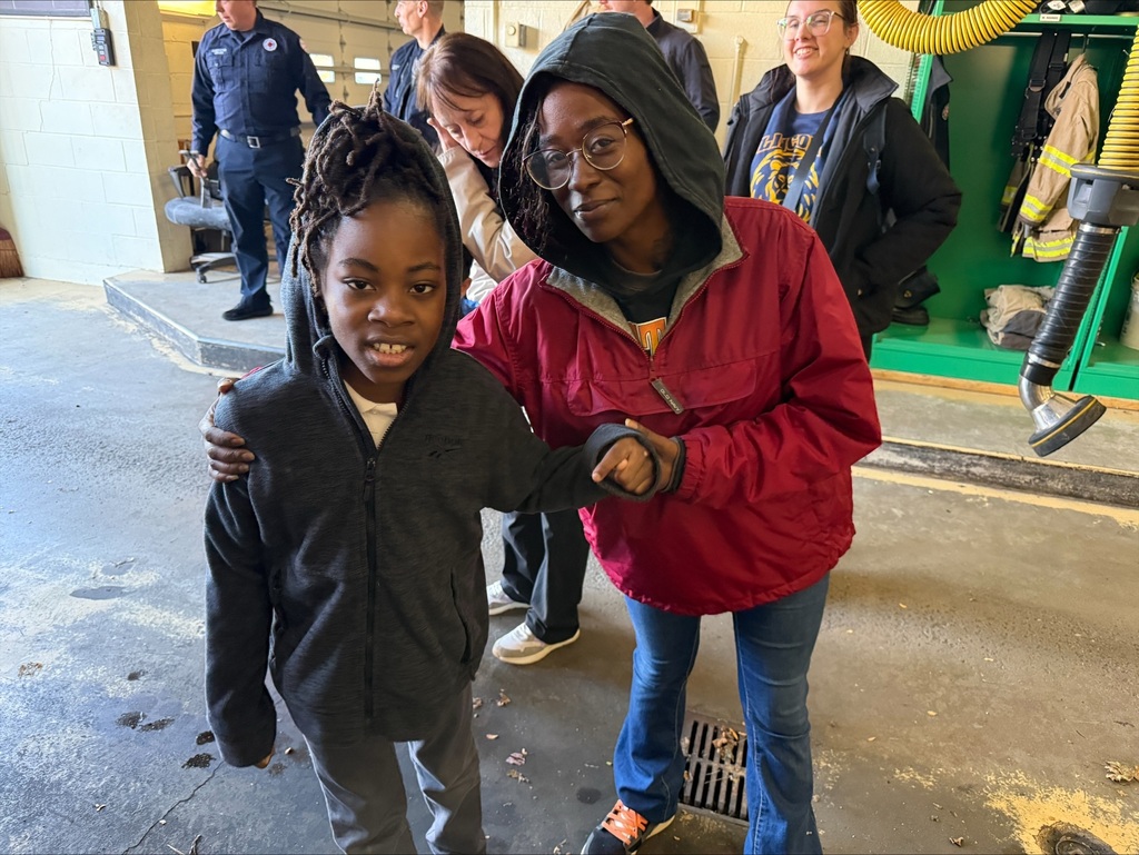 Student and teacher posing for a picture