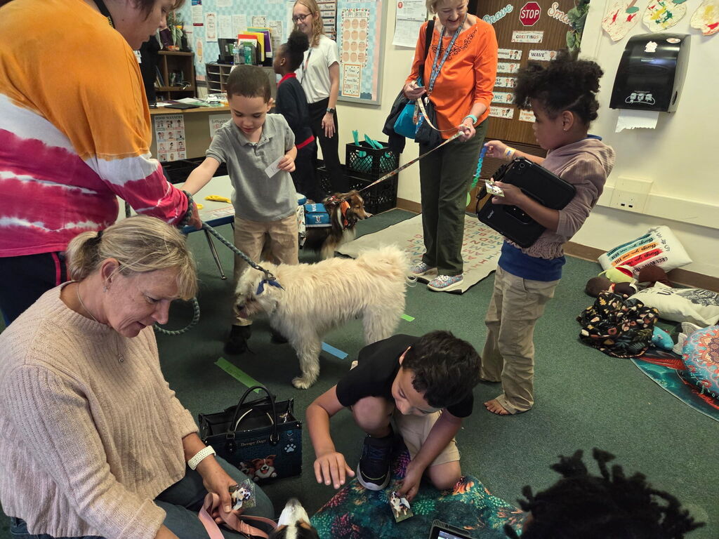 Students petting a therapy dog