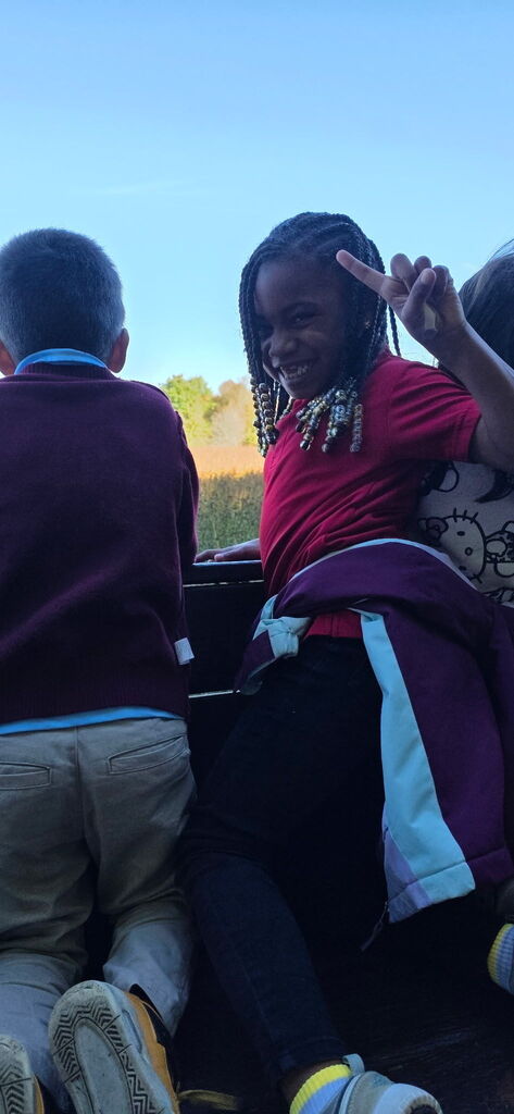 Students smiling on the tractor ride