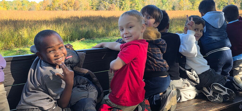 Students smiling on the tractor ride
