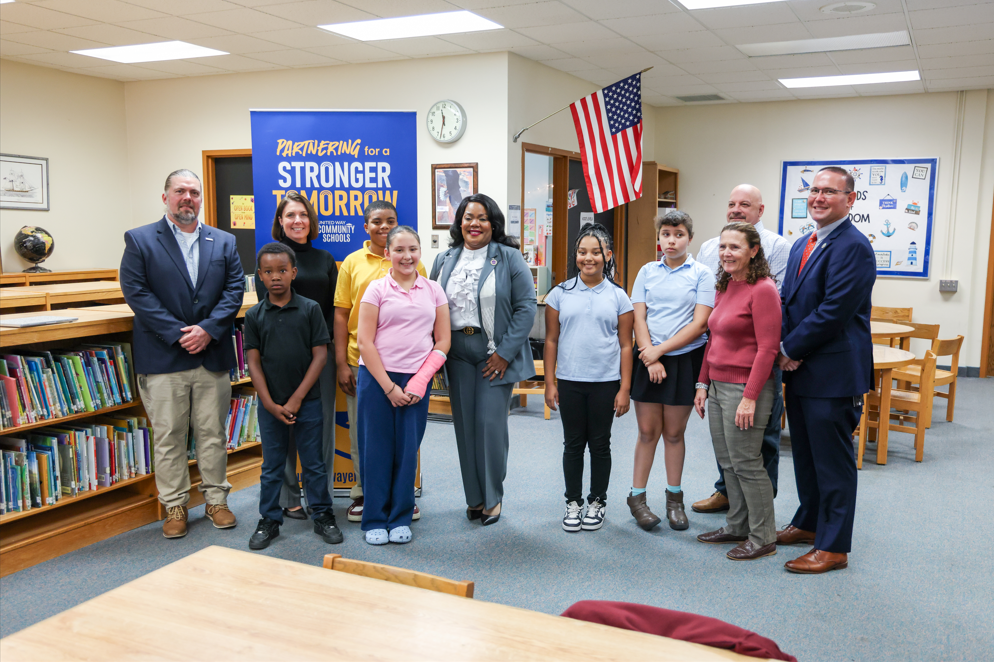 The guest speakers for the Perry Safer Walking Routs press conference which includes Mayor Daria Devlin and Superintendent/ CEO Dr. Natalyn Gibbs standing next to students.