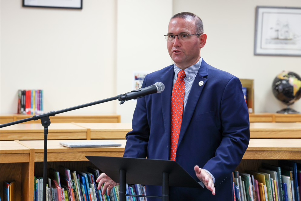 Supervisor of School and Community Safety, Matt Parker giving a speech at a podium.