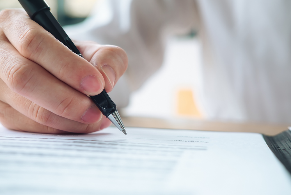 Signing a document.