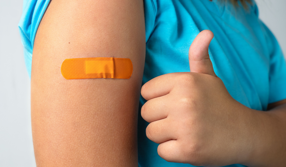 Child with bandaid on arm.