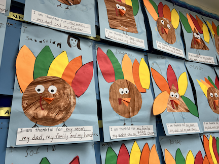 Student artwork of a turkey and stories of gratitude.